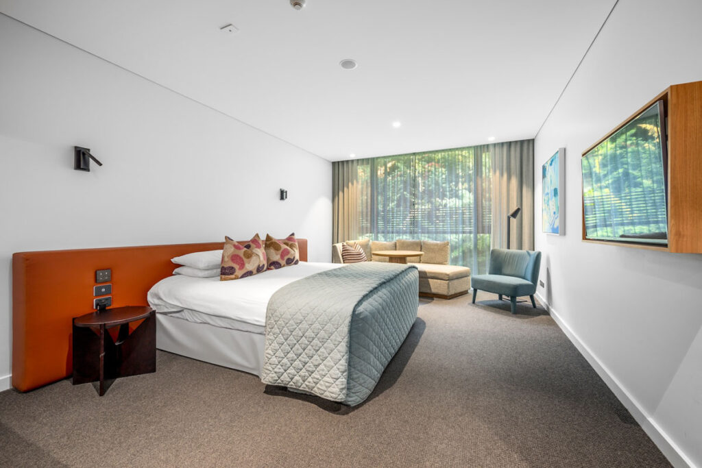 Modern hotel room with bed and sitting area