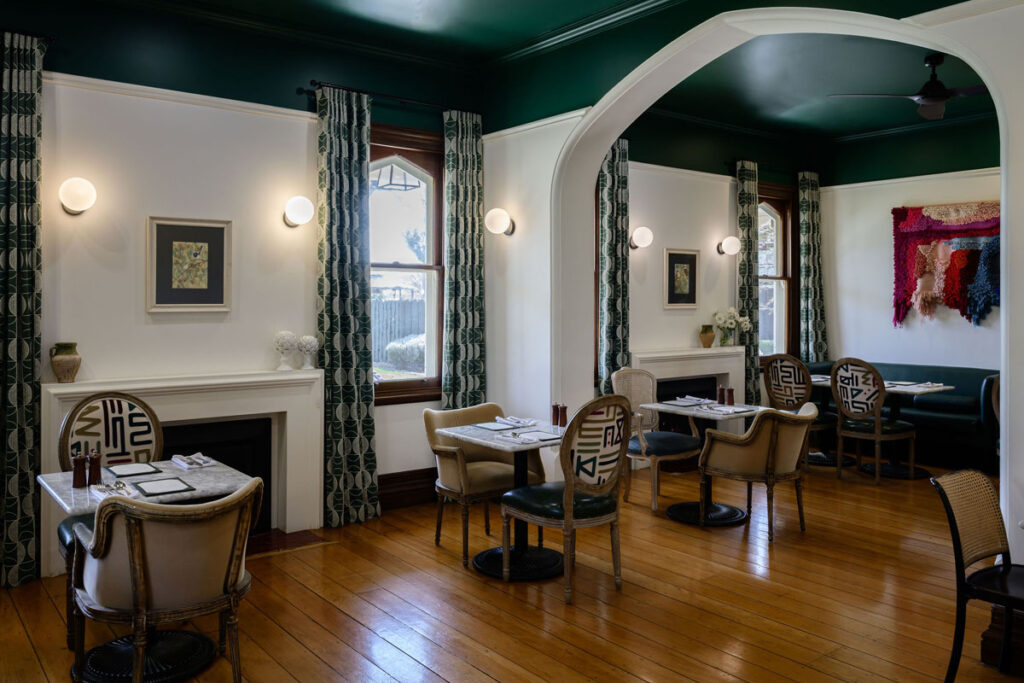 Cozy vintage café interior with wooden flooring and patterned chairs