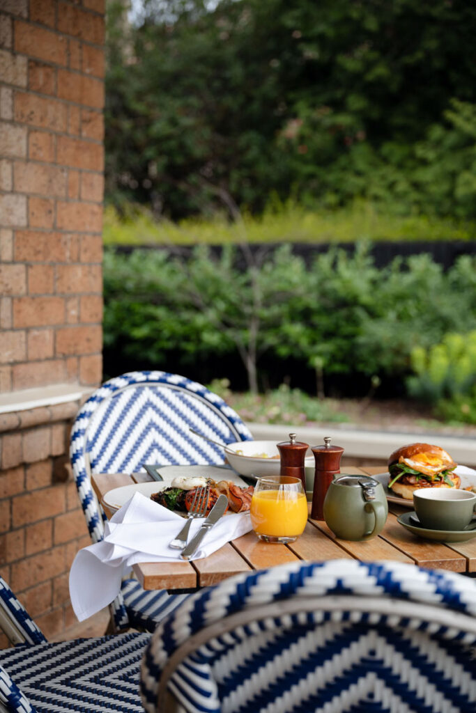 Outdoor breakfast table with food and drinks